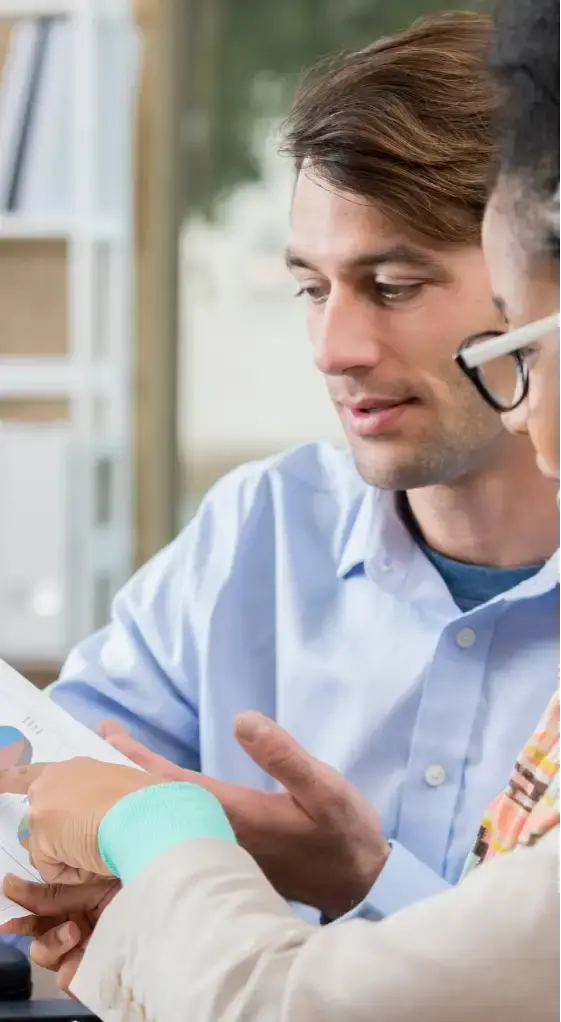 Accountant showing client a financial report. 