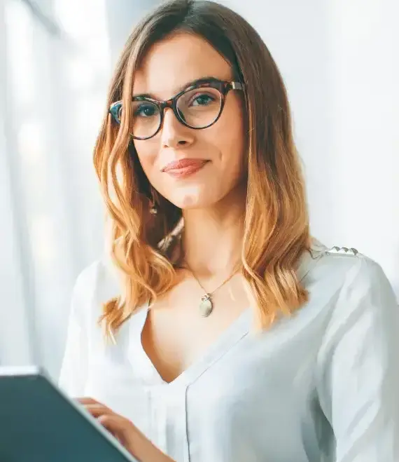 An accountant, expert in cloud accounting smiles at the camera. 